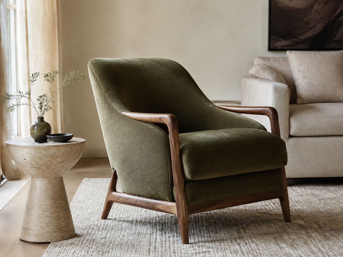 Editorial room inspiration: A sculptural olive lounge chair beside a honed stone side table in an inviting ivory living room