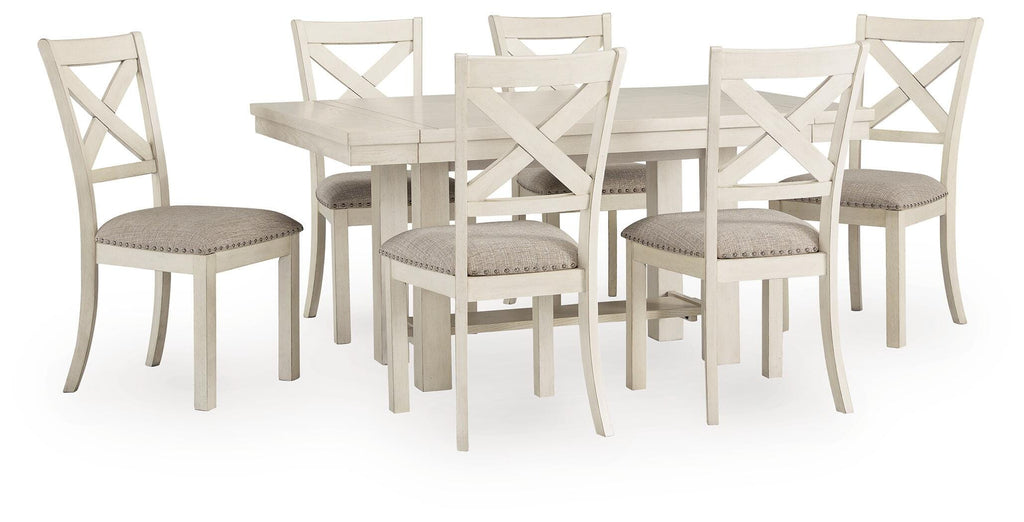 Robbinsdale antique white dining table with six upholstered chairs on white background